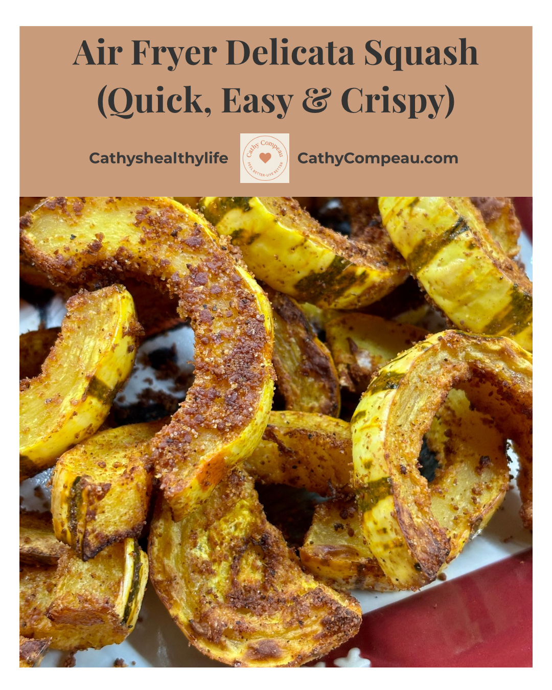 Air fryer delicata squash slices seasoned with Parmesan and spices, cooked until golden and crispy on a red serving plate.