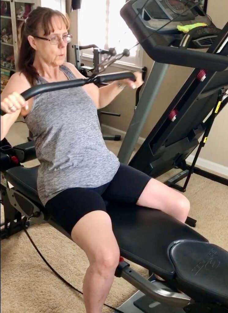 Middle aged woman working out - strength training. 