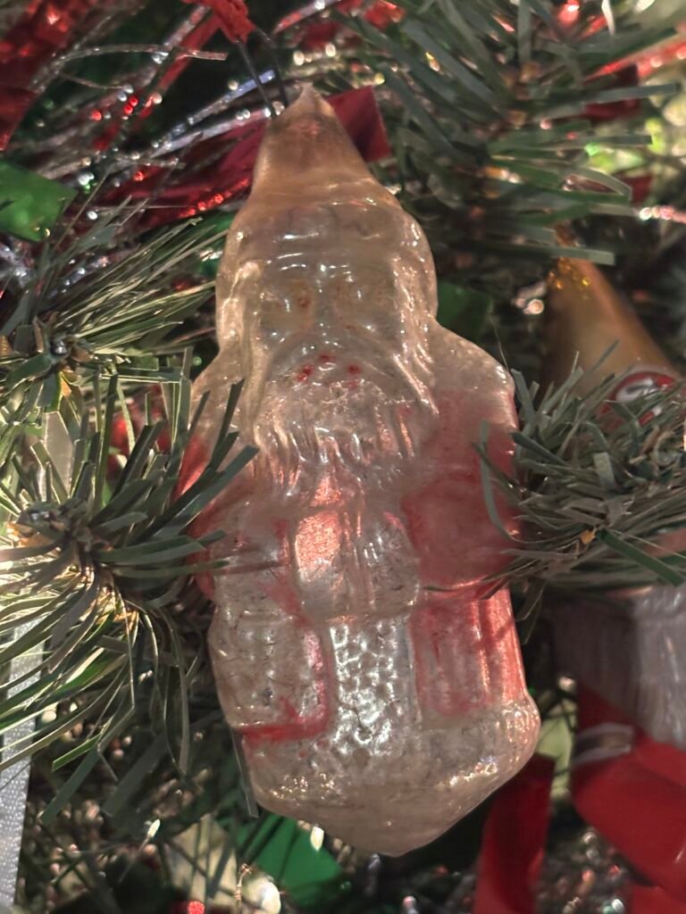 Glass ornament from the 1940s hanging on a Christmas tree in 2025
