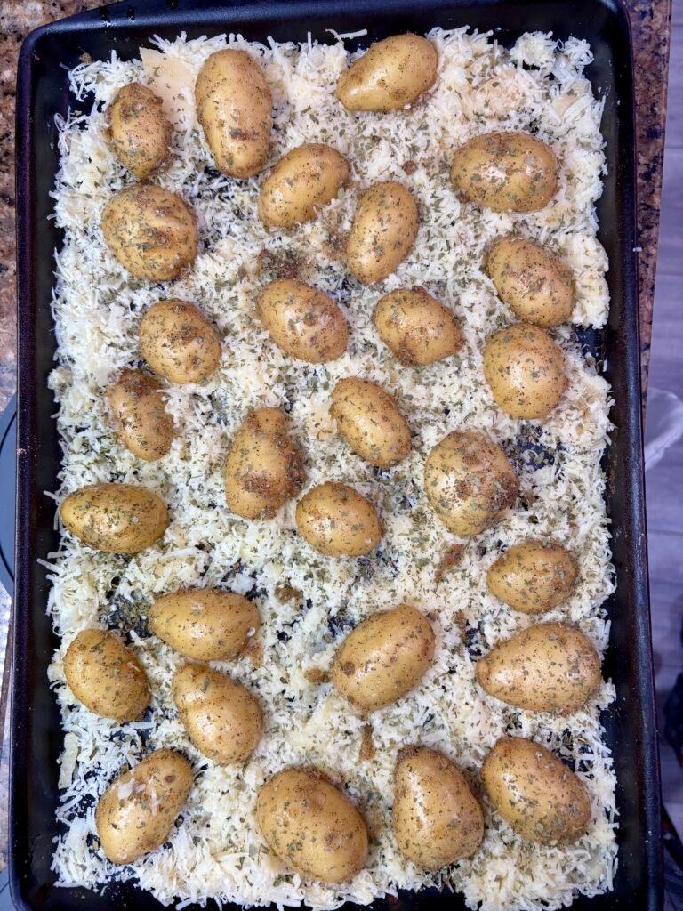 Seasoned potatoes pressed cut side down into Parmesan cheese crust