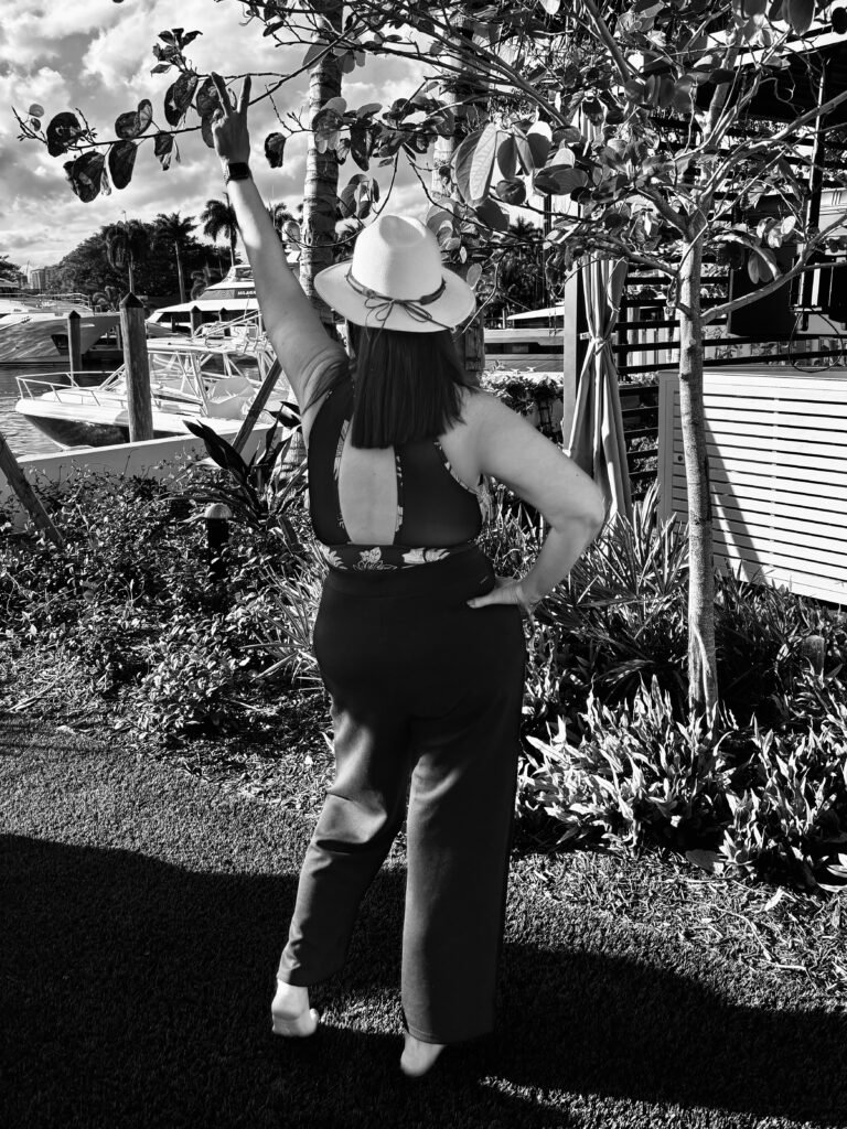 Strong and confident woman pointing to the sky.