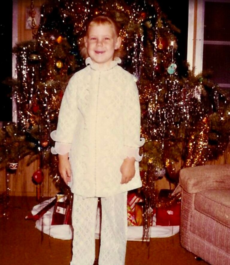 Little girl in front of the Christmas tree in the 1970’s