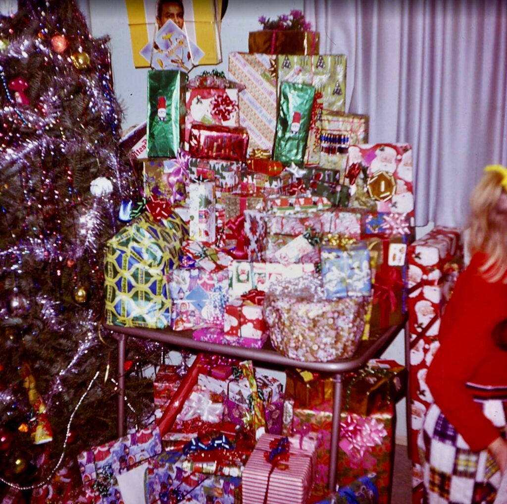 Presents stacked up on and around a card table in the living room in 1970s