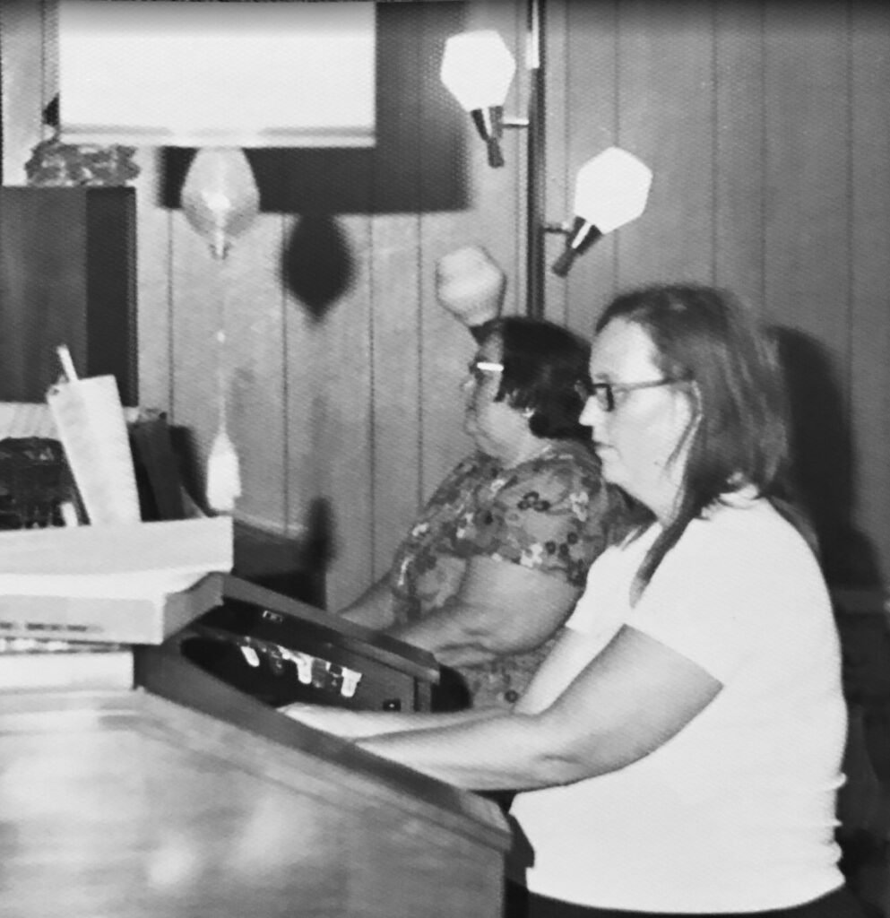 Two ladies playing the piano and organ