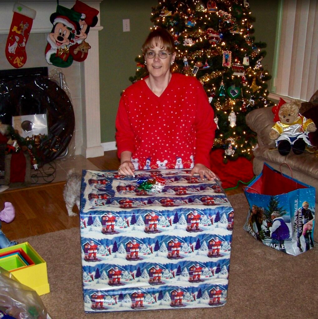 A mom happily opening a big Christmas gift she wanted.