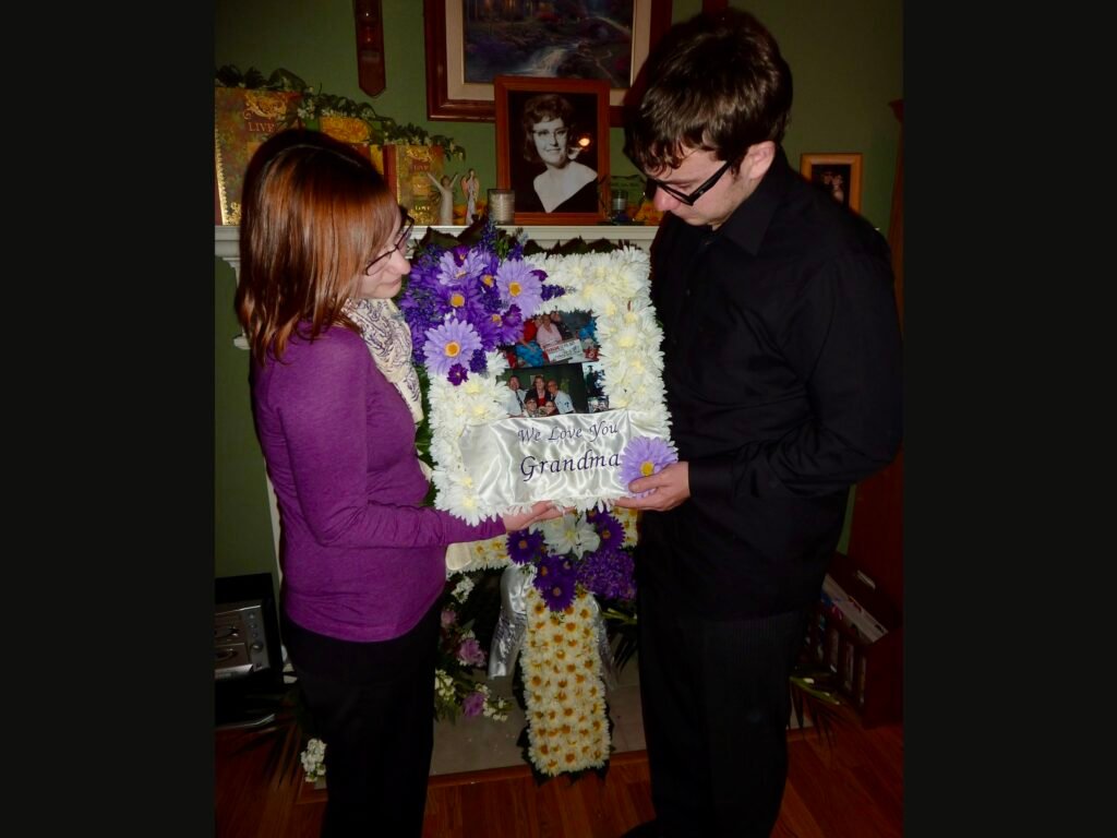 Grandchildren holding a photo framed of their grandmother passed away