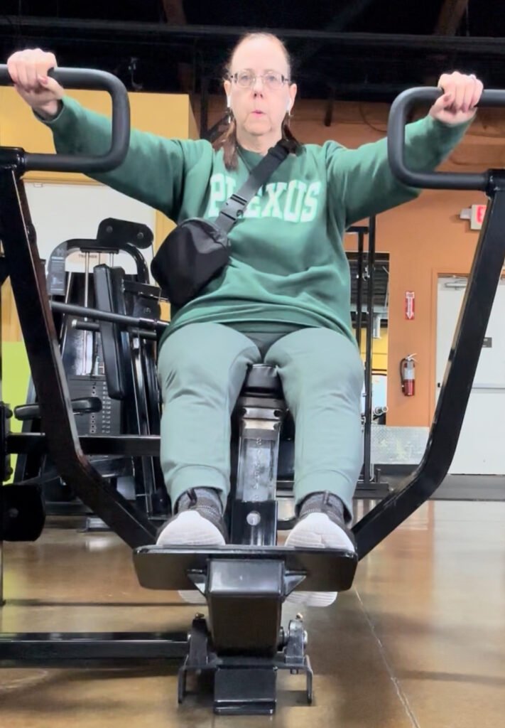 Middle aged woman working out - strength training at the gym