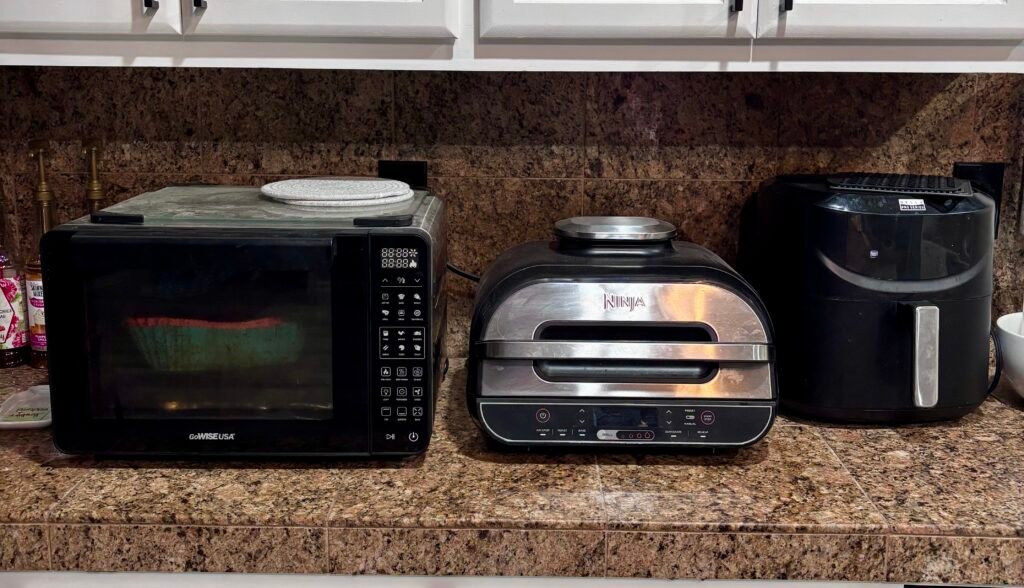 3 air fryers on the kitchen counter. 